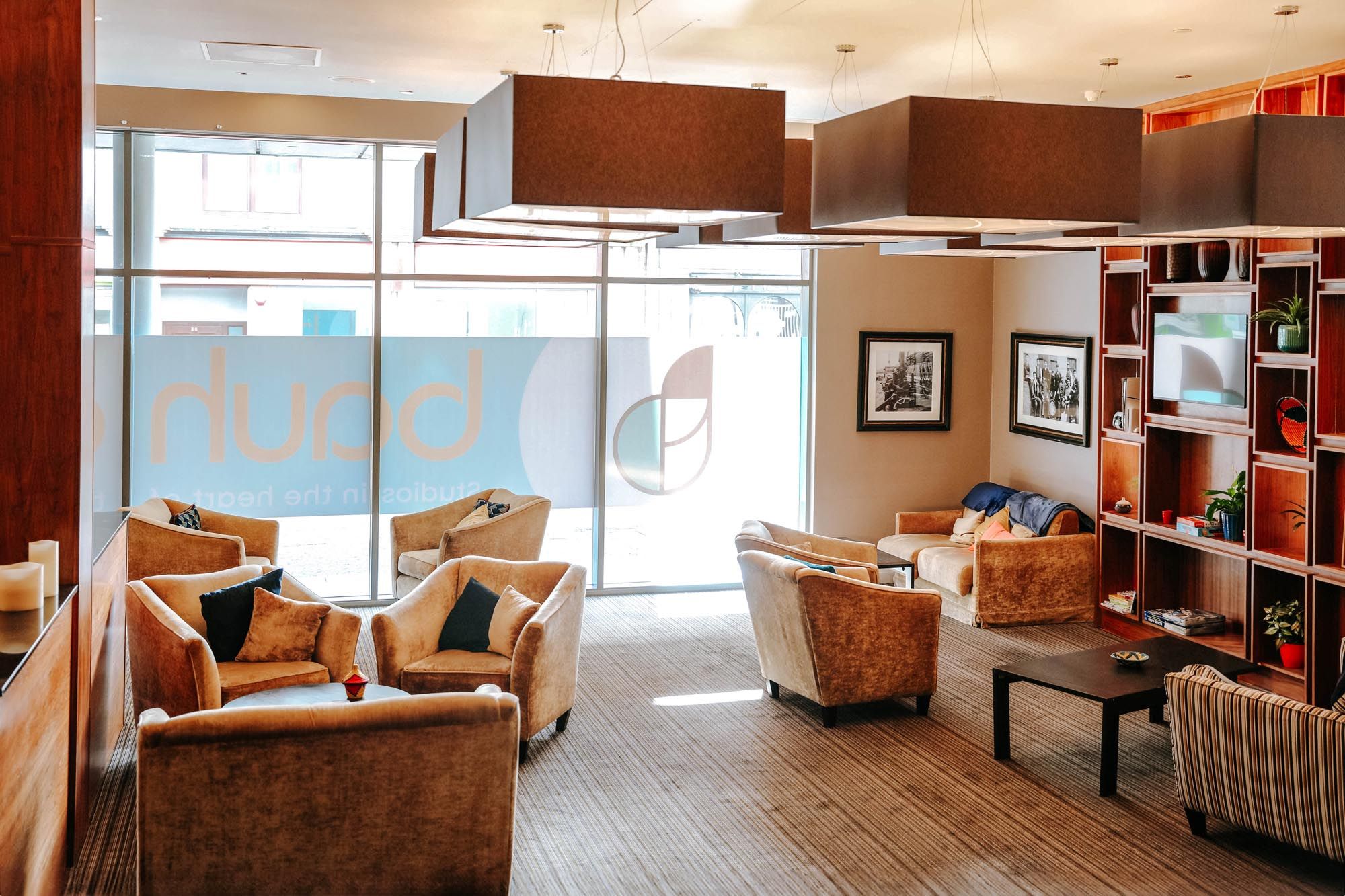 A shared socialising area in a bauhaus student accommodation with several many comfortable seats