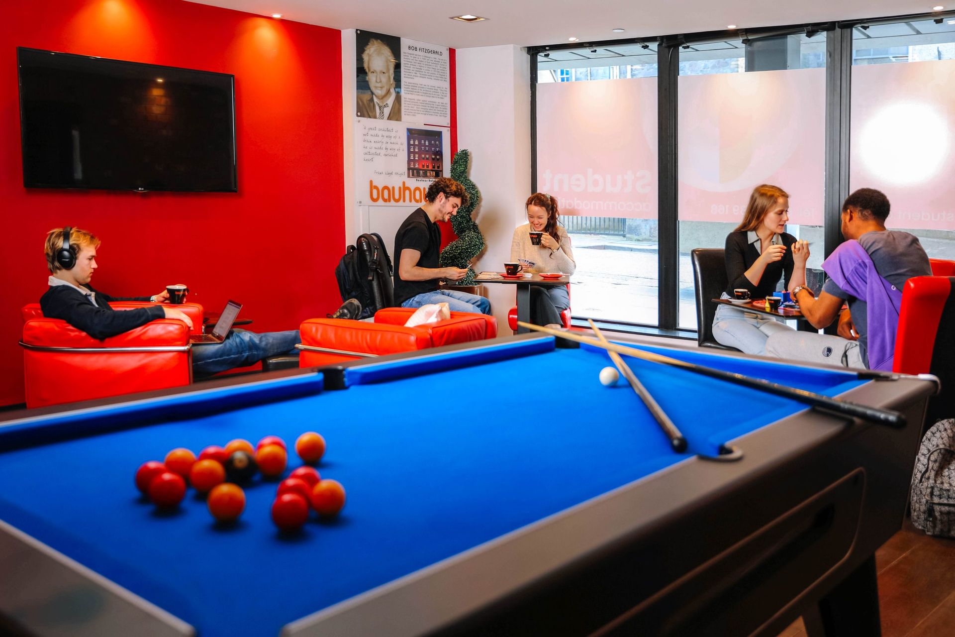 A shot of students studying, socialising and playing board games in a communal area of the langstane place student accommodation