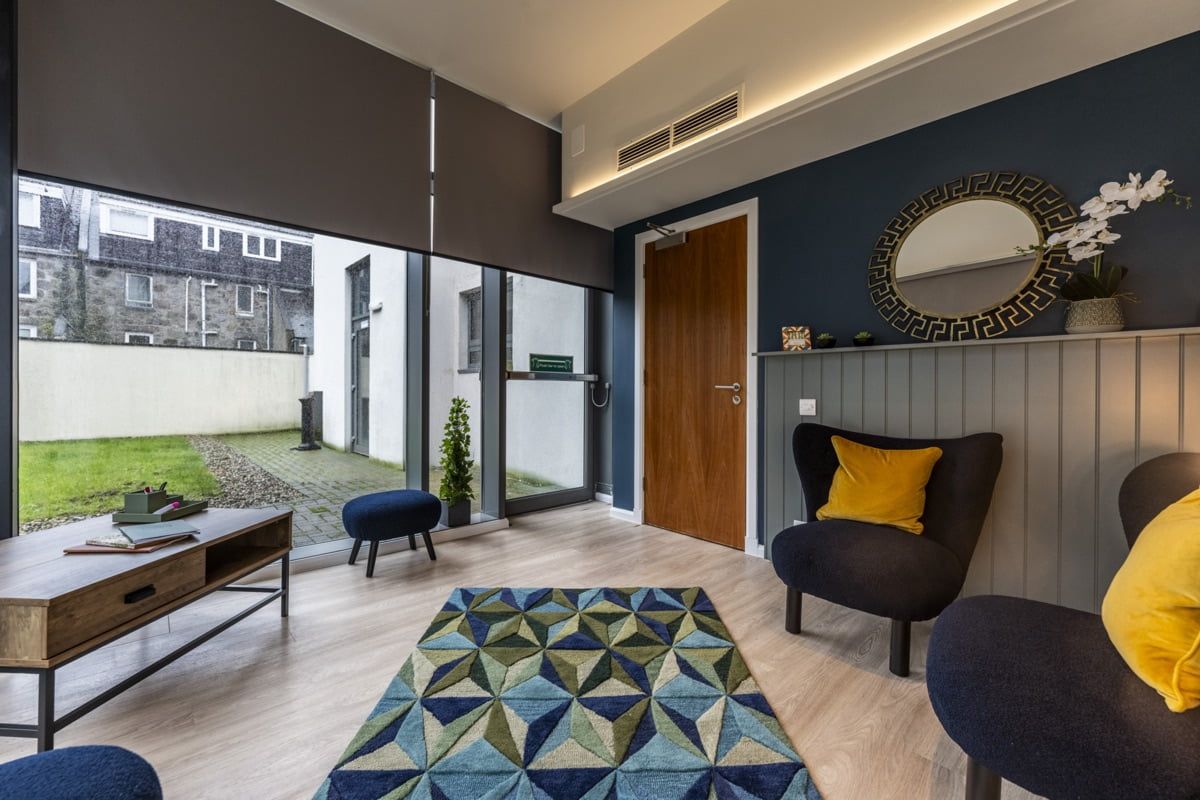 A stylish living area in a ground floor apartment in the St Andrews Street Bauhaus student accommodation highlighting a spacious yard